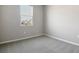 Cozy bedroom with neutral walls, plush carpet, and a bright window view at 5422 Catmint Dr, Lake Hamilton, FL 33851