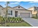 Charming single-story home with a two-car garage, manicured lawn, and inviting front door at 5422 Catmint Dr, Lake Hamilton, FL 33851