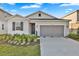 Charming single-story home with a two-car garage, manicured lawn, and inviting front door at 5422 Catmint Dr, Lake Hamilton, FL 33851