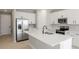 Modern kitchen featuring white cabinets, stainless steel appliances, and a spacious center island at 5422 Catmint Dr, Lake Hamilton, FL 33851