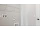 The laundry room features a white wire shelf, and hookups for a washer and dryer at 5422 Catmint Dr, Lake Hamilton, FL 33851