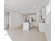 Bright, open-concept kitchen with white cabinets, stainless appliances, and tile flooring at 5422 Catmint Dr, Lake Hamilton, FL 33851