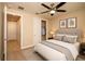Comfortable bedroom with plush carpeting, ceiling fan and en-suite access at 7845 Wandering Way, Orlando, FL 32836