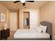 This cozy bedroom offers a calm retreat with neutral tones and ample closet space at 7845 Wandering Way, Orlando, FL 32836