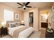 Comfortable bedroom featuring neutral tones, ceiling fan and view to ensuite bathroom at 7845 Wandering Way, Orlando, FL 32836