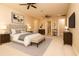 Expansive main bedroom featuring ceiling fan, seating and a view to main bathroom at 7845 Wandering Way, Orlando, FL 32836