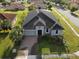 Well maintained single-story home featuring a brick driveway, a two-car garage, and lush landscaping at 3907 Golden Knot Dr, Kissimmee, FL 34746
