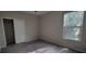 This empty bedroom offers a spacious layout, ample natural light, and neutral carpeting at 3907 Golden Knot Dr, Kissimmee, FL 34746