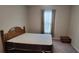 Simple bedroom with a wooden bed frame and window at 3907 Golden Knot Dr, Kissimmee, FL 34746