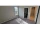 Bedroom with neutral walls, carpet flooring, and a window for natural light, adjacent to the bathroom at 3907 Golden Knot Dr, Kissimmee, FL 34746