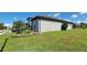 Well-maintained home exterior with lush green lawn, mature landscaping, and a side-entry garage on a sunny day at 3907 Golden Knot Dr, Kissimmee, FL 34746