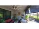 Screened lanai features a ceiling fan, ample seating and potted plants, perfect for relaxing outdoors at 3907 Golden Knot Dr, Kissimmee, FL 34746