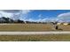 View of expansive parcel of land with sidewalk along the front and various single Gathering homes in the background at 3907 Golden Knot Dr, Kissimmee, FL 34746