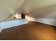 Finished attic featuring wood flooring, exposed brick, and natural light at 701 1St Ne St, Fort Meade, FL 33841