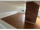 Spacious attic with wood floors, exposed brick, and natural light at 701 1St Ne St, Fort Meade, FL 33841