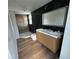 Modern bathroom with a double sink vanity, stylish lighting, and a walk-in shower at 701 1St Ne St, Fort Meade, FL 33841