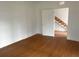 Bedroom with wood-look flooring and a view of the stairs at 701 1St Ne St, Fort Meade, FL 33841