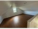 Spacious bonus room with sloped ceilings and wood-look floors at 701 1St Ne St, Fort Meade, FL 33841