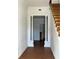 Inviting entryway featuring wood flooring, decorative columns, and stairs leading to the upper level at 701 1St Ne St, Fort Meade, FL 33841