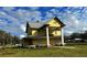 Exterior view of yellow home with large columns on a sunny day at 701 1St Ne St, Fort Meade, FL 33841