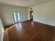 Living room featuring wood flooring, white walls, and doors leading to an outdoor space at 701 1St Ne St, Fort Meade, FL 33841