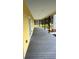 Long, covered porch with composite decking and dark-stained wood beams at 701 1St Ne St, Fort Meade, FL 33841