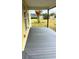 Long, covered porch with composite decking and views of the yard at 701 1St Ne St, Fort Meade, FL 33841