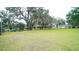 Large backyard with mature oak trees and a partially visible home at 8836 Sr 471 Hwy, Webster, FL 33597