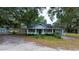 Rustic cottage exterior surrounded by oak trees at 8836 Sr 471 Hwy, Webster, FL 33597