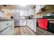 Efficient kitchen with stainless steel appliances and wood-look floors at 8836 Sr 471 Hwy, Webster, FL 33597