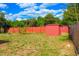 Spacious backyard with a shed and a charming red fence. Perfect for outdoor activities and relaxation at 1053 Hemingway Dr, Deltona, FL 32725