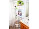 Bathroom featuring a shower-tub combo and storage solutions at 1053 Hemingway Dr, Deltona, FL 32725