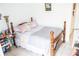 Bright bedroom with tile floors with a bed, side table and personal care items at 1053 Hemingway Dr, Deltona, FL 32725