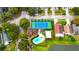 Aerial view of community amenities, including a pool, tennis court, playground, and lake at 2112 Fish Eagle St, Clermont, FL 34714