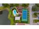 Aerial view of community amenities, including a pool, tennis court, playground, and lake at 2112 Fish Eagle St, Clermont, FL 34714