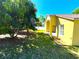 Large backyard featuring mature trees and a bright yellow home at 2112 Fish Eagle St, Clermont, FL 34714