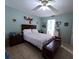 This primary bedroom features a ceiling fan, tile floors, and an ensuite bathroom at 2112 Fish Eagle St, Clermont, FL 34714