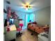 Bright bedroom with colorful decor, a comfortable bed, and a dedicated study area at 2112 Fish Eagle St, Clermont, FL 34714