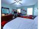 Bright bedroom features two windows, a ceiling fan, and themed decor at 2112 Fish Eagle St, Clermont, FL 34714