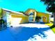 Charming home featuring a two-car garage, well-manicured lawn, and an inviting arched entryway at 2112 Fish Eagle St, Clermont, FL 34714