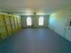 Spacious garage with an epoxy floor and two arched windows at 2112 Fish Eagle St, Clermont, FL 34714