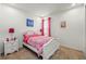 Comfortable bedroom with white furniture, carpeted floors, and soft pink accents at 3878 Carrick Bend Dr, Kissimmee, FL 34746