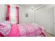 Cozy bedroom with a plush bed and bright pink curtains for a pop of color at 3878 Carrick Bend Dr, Kissimmee, FL 34746
