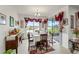 Formal dining area with a view of the lake, elegant décor, and abundant natural light at 3878 Carrick Bend Dr, Kissimmee, FL 34746
