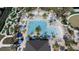 Aerial view showcasing a luxury community pool with a mini golf course, palm trees and lounge seating at 712 Whistling Straits Blvd, Davenport, FL 33896
