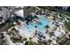 Aerial view of a stunning community pool area, surrounded by palm trees, lounge chairs, and inviting umbrellas at 712 Whistling Straits Blvd, Davenport, FL 33896