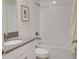 Bright full bathroom features shower-tub combo with white tiling, neutral walls, and modern fixtures at 712 Whistling Straits Blvd, Davenport, FL 33896