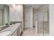 Bathroom with dual sinks, grey countertops, and a glass-enclosed shower offering a modern and functional design at 712 Whistling Straits Blvd, Davenport, FL 33896