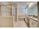 Bright primary bathroom featuring a glass-enclosed shower, soaking tub, and double vanity with modern fixtures at 712 Whistling Straits Blvd, Davenport, FL 33896