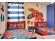 Vibrant bedroom with Spiderman themed bedding, decor, and mural on the wall at 712 Whistling Straits Blvd, Davenport, FL 33896